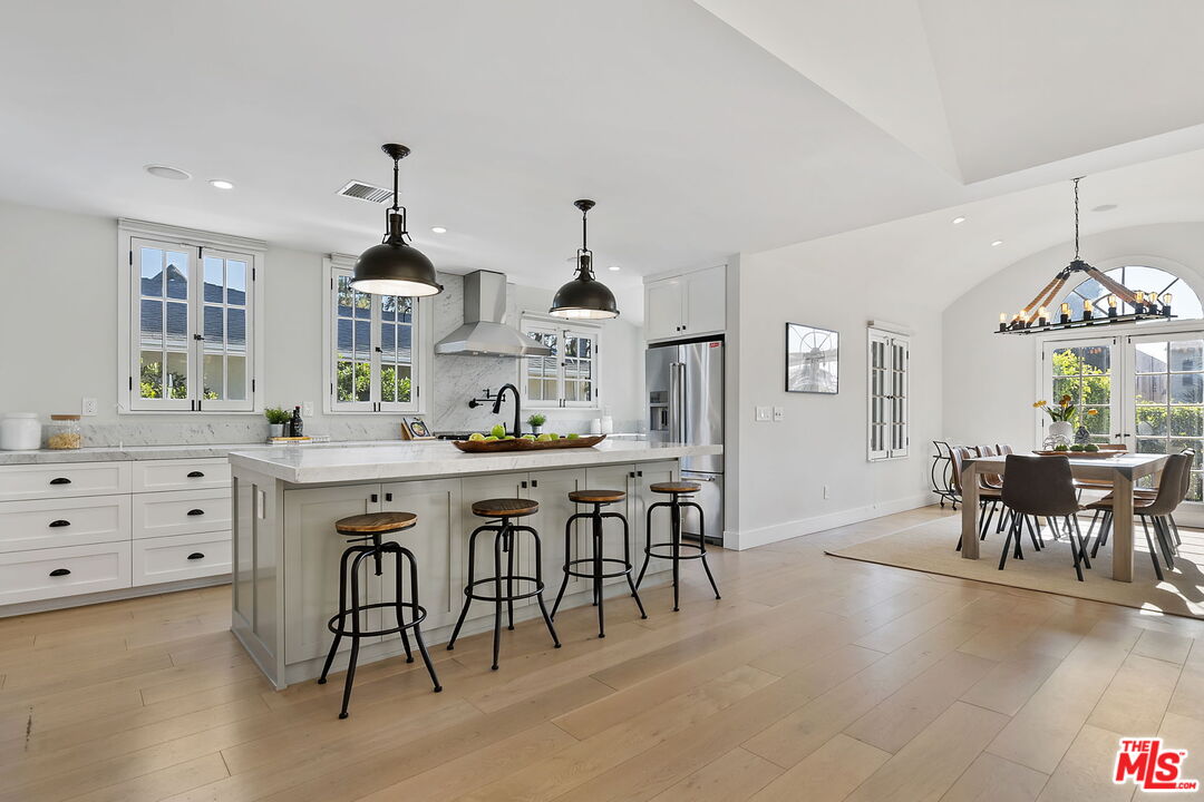 6507 West Olympic Boulevard Los Angeles, CA 90048 - Photo 14 of 50 a kitchen with kitchen island granite countertop a table and chairs in it