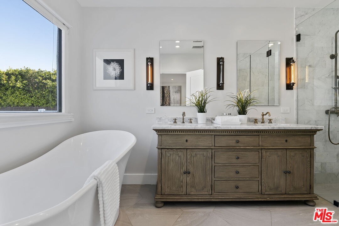 6507 West Olympic Boulevard Los Angeles, CA 90048 - Photo 24 of 50 a bathroom with a double vanity sink a mirror and a bathtub