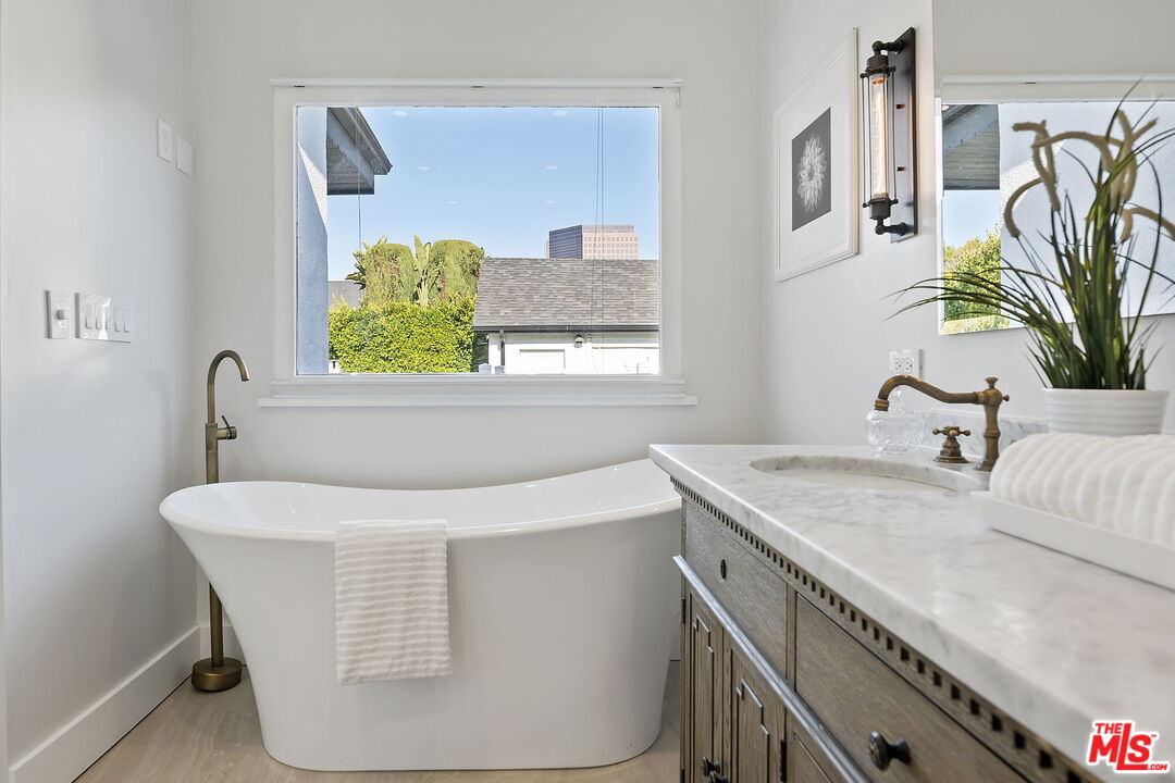 6507 West Olympic Boulevard Los Angeles, CA 90048 - Photo 26 of 50 a bathroom with a sink and a mirror