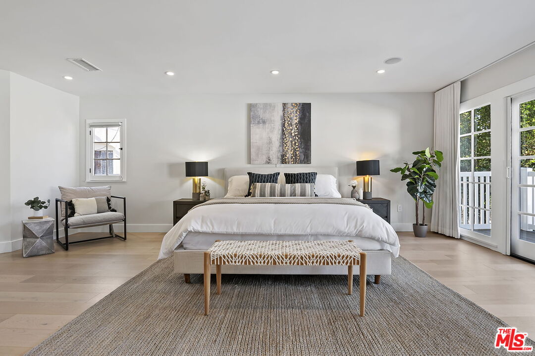6507 West Olympic Boulevard Los Angeles, CA 90048 - Photo 27 of 50 a bed sitting in a spacious bedroom next to a window and a couch