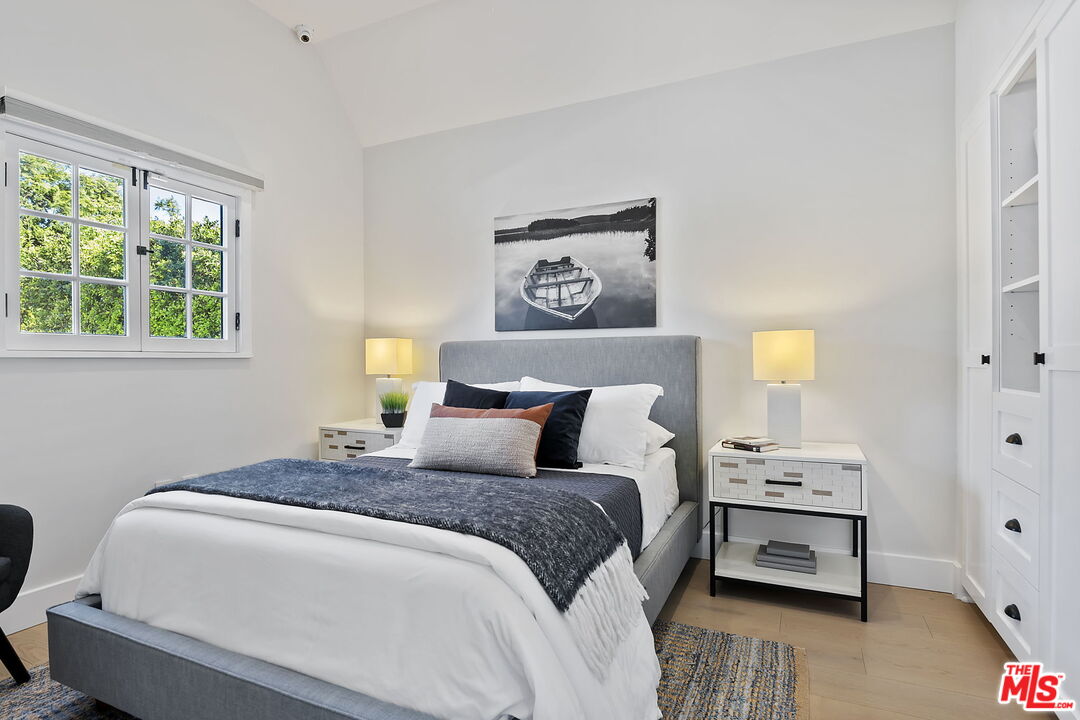 6507 West Olympic Boulevard Los Angeles, CA 90048 - Photo 30 of 50 a bedroom with a bed and wooden floor