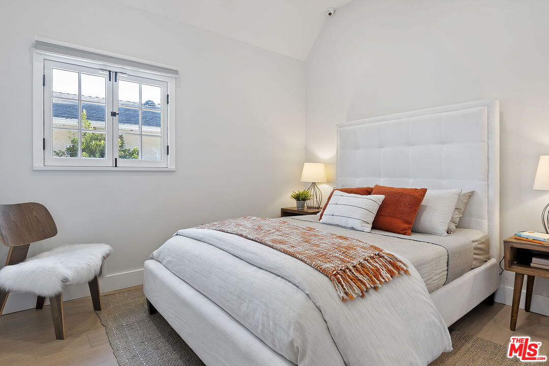 6507 West Olympic Boulevard Los Angeles, CA 90048 - Photo 32 of 50 a bedroom with a bed a couch and a window