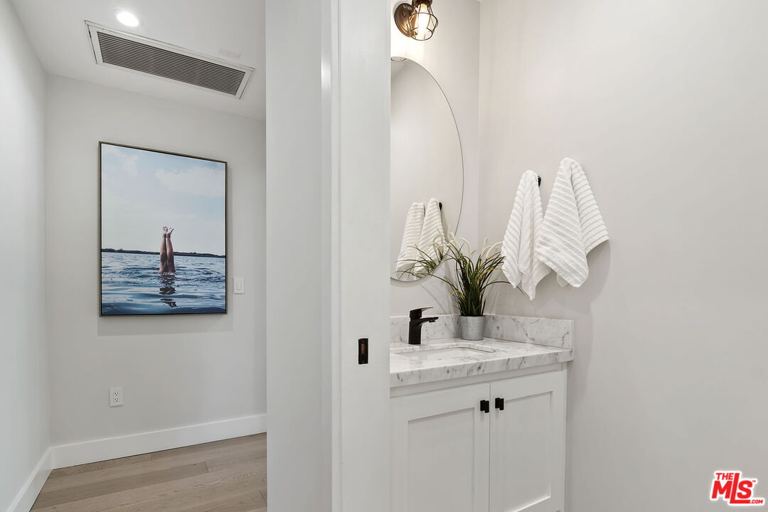 6507 West Olympic Boulevard Los Angeles, CA 90048 - Photo 33 of 50 a bathroom with a sink and a mirror