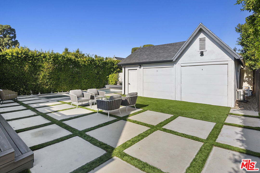 6507 West Olympic Boulevard Los Angeles, CA 90048 - Photo 37 of 50 a view of a house with backyard sitting area and garden