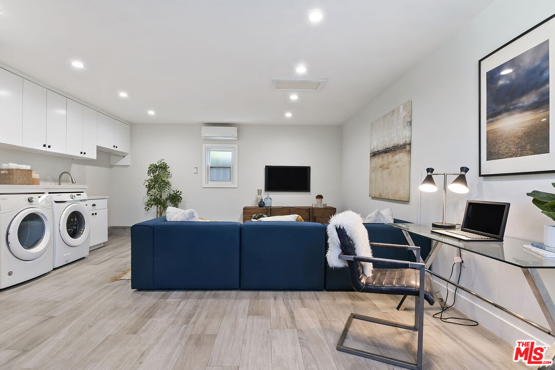 6507 West Olympic Boulevard Los Angeles, CA 90048 - Photo 45 of 50 a living room with furniture a flat screen tv and rug