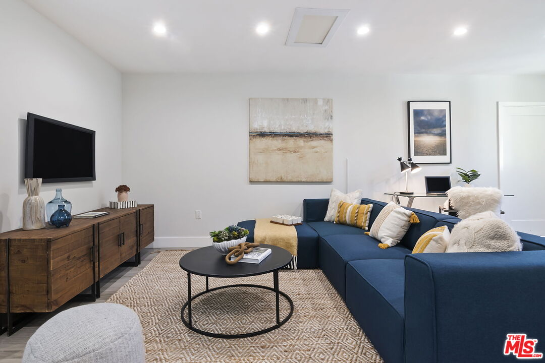 6507 West Olympic Boulevard Los Angeles, CA 90048 - Photo 46 of 50 a living room with furniture and a flat screen tv