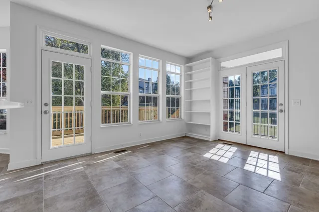 a bathroom with a tub a window and a shower