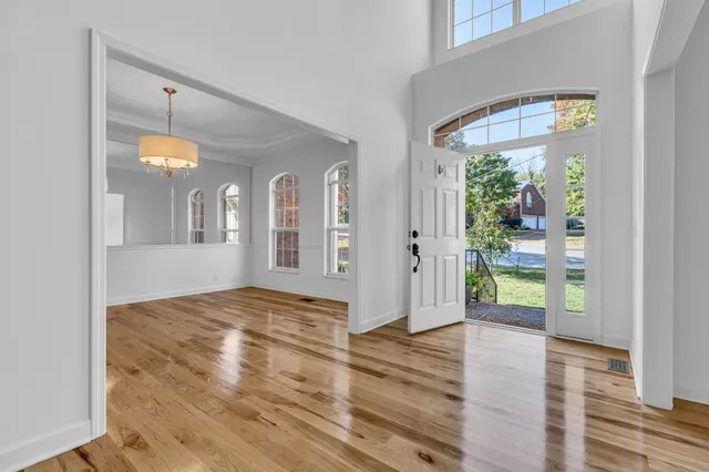 a view of entryway and hall with wooden floor