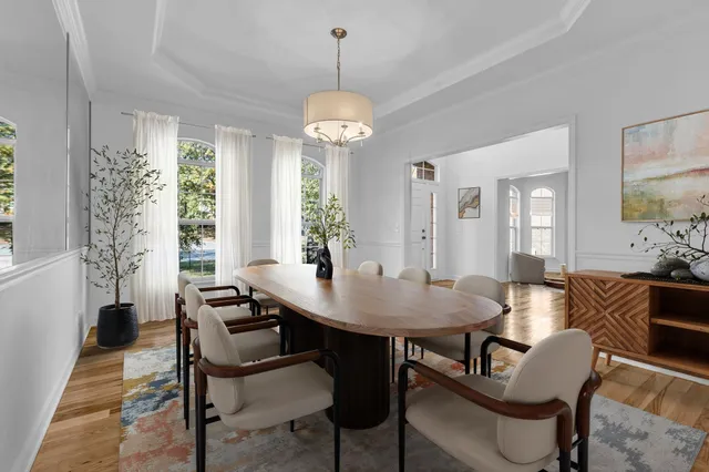 a living room with furniture a fireplace and potted plants