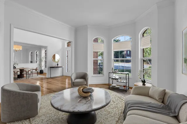 a dining room with furniture window and wooden floor