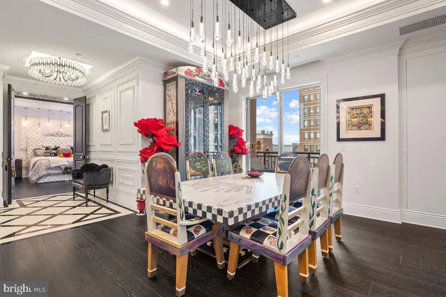 a view of a dining room with furniture a chandelier and wooden floor
