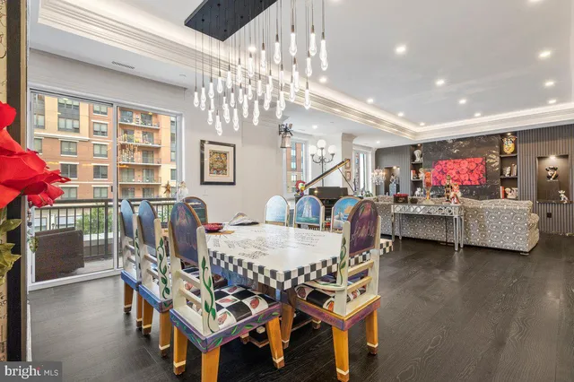 a view of a dining room with furniture and chandelier