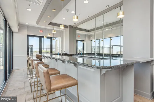 a living room with furniture a large window and a flat screen tv