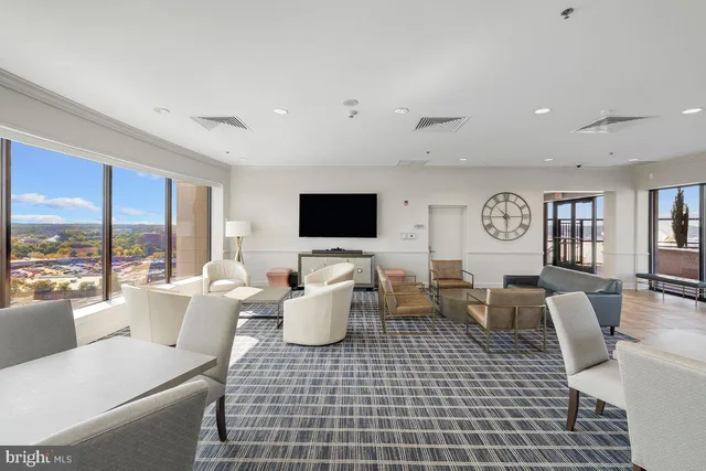 a view of a swimming pool with outdoor seating