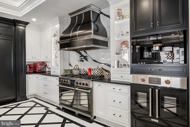 a kitchen with stainless steel appliances granite countertop a stove and cabinets