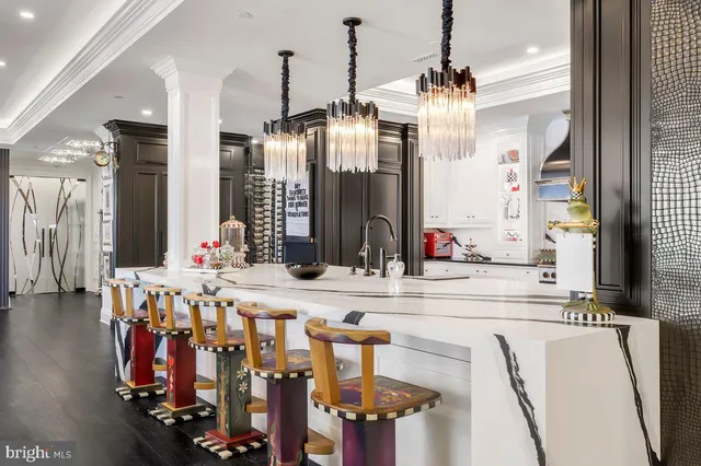 a view of dining table chairs and chandelier