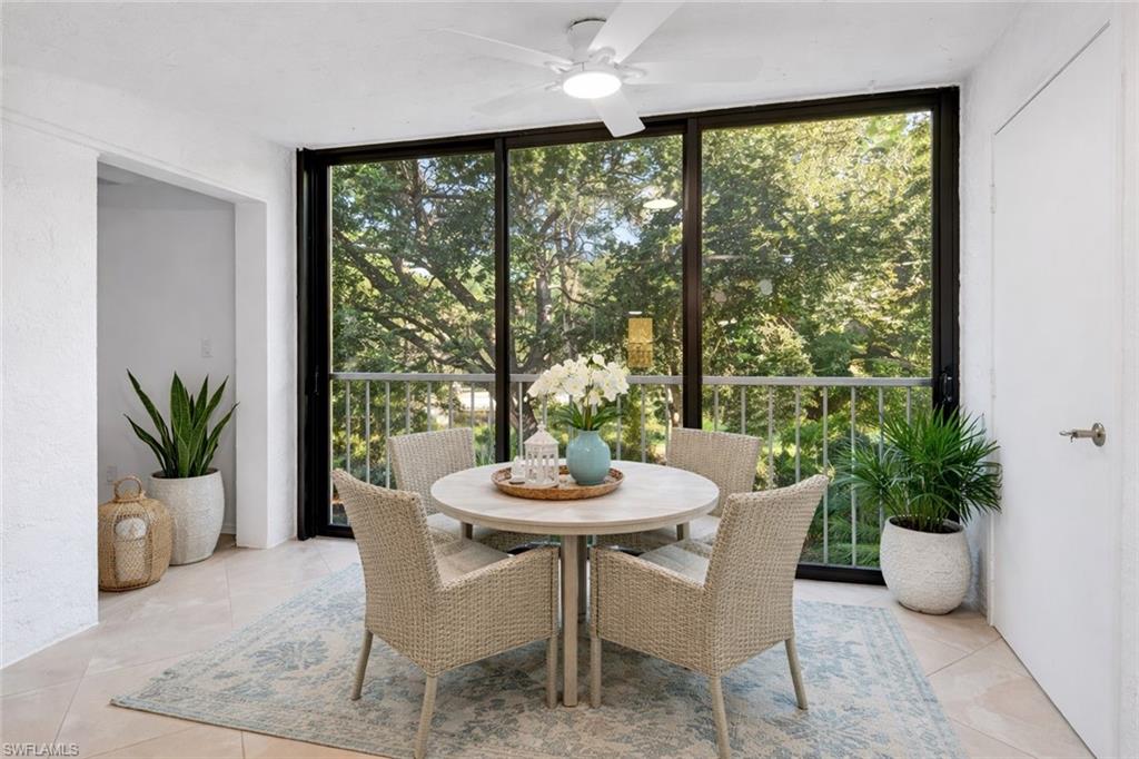 1001 Foxfire Lane, Unit 204 Naples, FL 34104 - Photo 11 of 35 a dining room with furniture window and wooden floor
