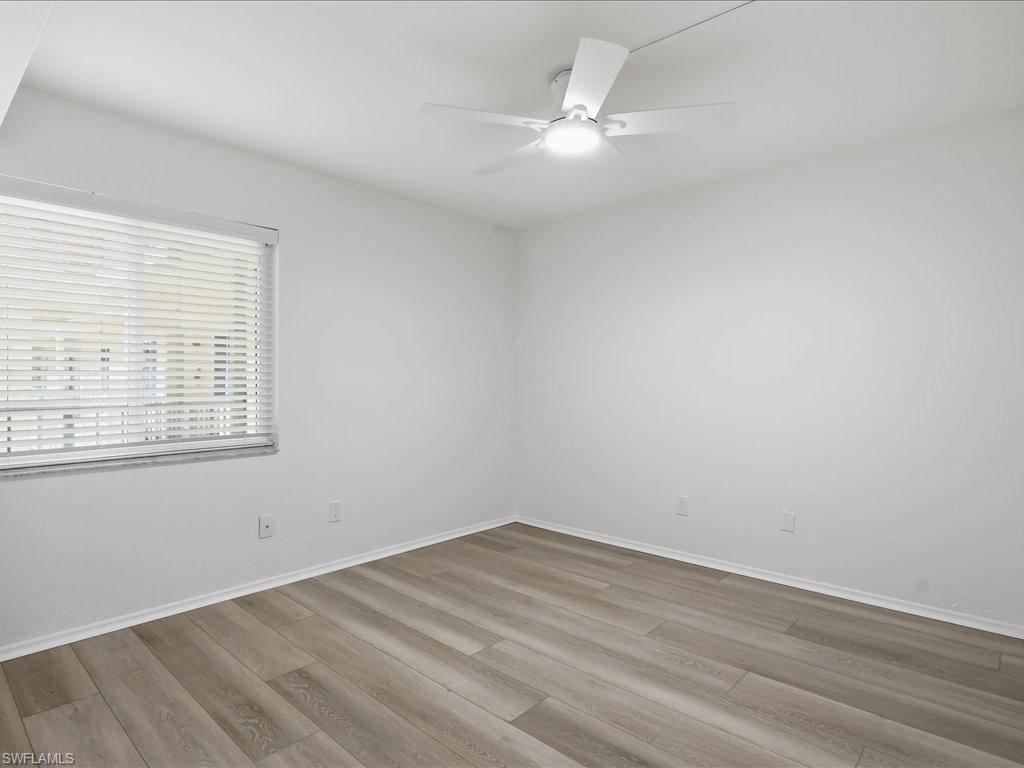 1001 Foxfire Lane, Unit 204 Naples, FL 34104 - Photo 17 of 35 wooden floor in an empty room with a window
