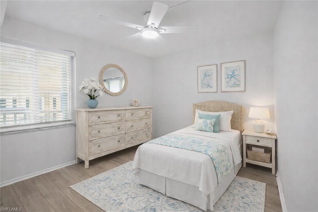 1001 Foxfire Lane, Unit 204 Naples, FL 34104 - Photo 18 of 35 a bedroom with a bed and a dresser