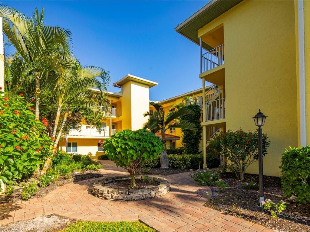 1001 Foxfire Lane, Unit 204 Naples, FL 34104 - Photo 22 of 35 a front view of a house with garden