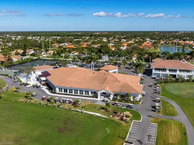 an aerial view of residential houses with outdoor space and swimming pool