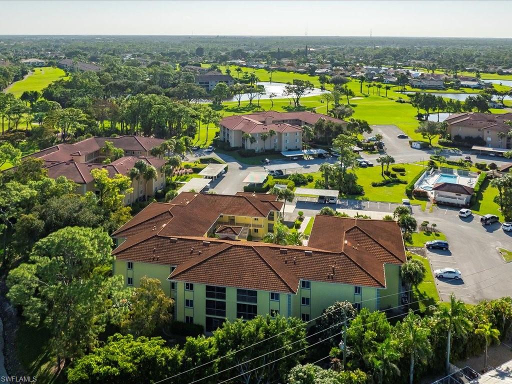 1001 Foxfire Lane, Unit 204 Naples, FL 34104 - Photo 29 of 35 an aerial view of house with yard swimming pool and outdoor seating