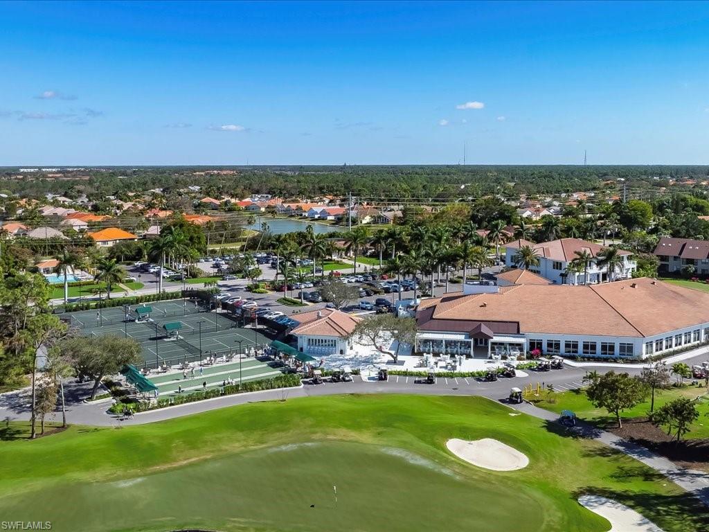 1001 Foxfire Lane, Unit 204 Naples, FL 34104 - Photo 32 of 35 an aerial view of a house with a swimming pool outdoor seating and yard