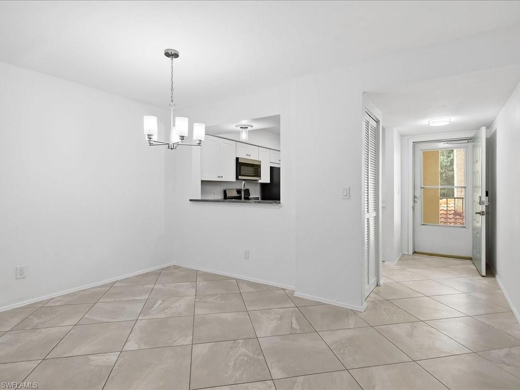 1001 Foxfire Lane, Unit 204 Naples, FL 34104 - Photo 6 of 35 a view of a kitchen with an empty space and a window