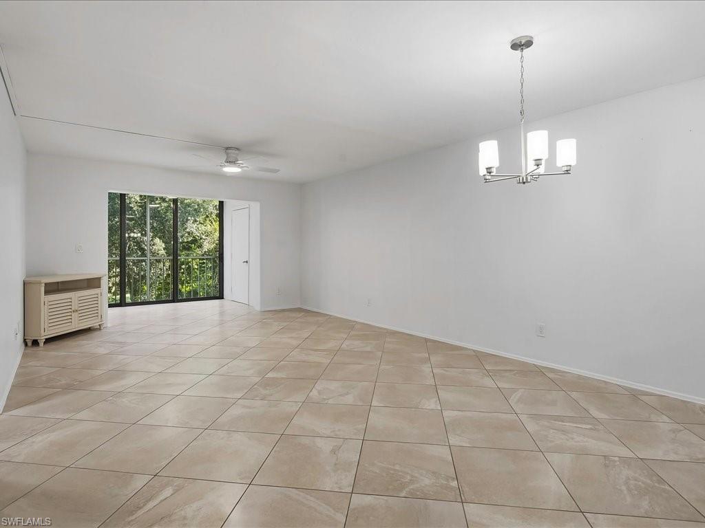 1001 Foxfire Lane, Unit 204 Naples, FL 34104 - Photo 7 of 35 wooden floor in an empty room with a window