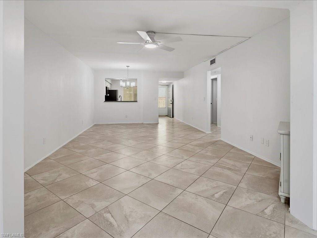1001 Foxfire Lane, Unit 204 Naples, FL 34104 - Photo 9 of 35 an empty room with windows and cabinet
