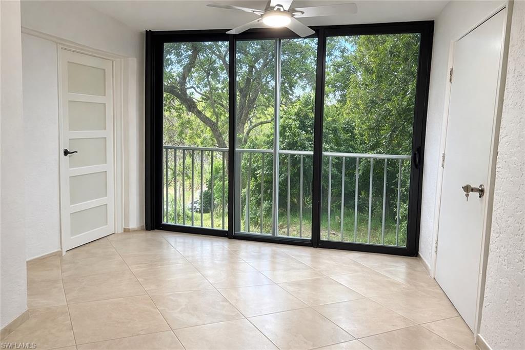 1001 Foxfire Lane, Unit 204 Naples, FL 34104 - Photo 10 of 35 a view of a room with large windows and plants