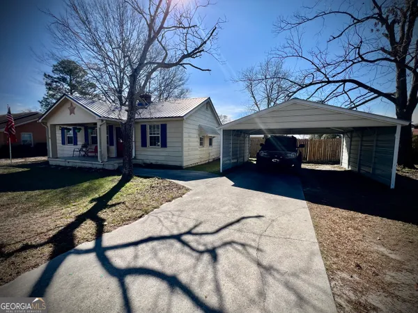 a front view of a house with a yard covered in snow