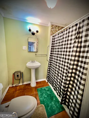 a bathroom with a sink toilet and mirror