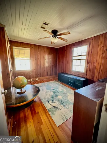 a living room with a sink and a wooden floor