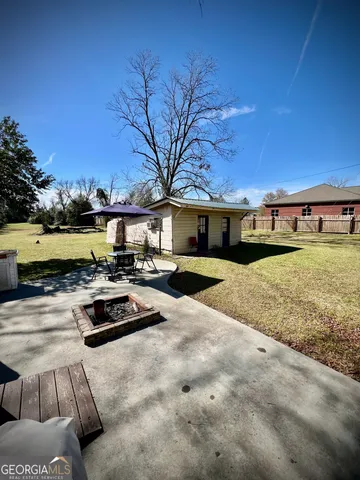 a view of house with outdoor space and seating area