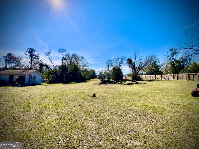 a view of large swimming pool and an outdoor space