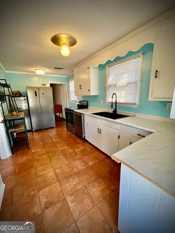 a kitchen with stainless steel appliances granite countertop a sink and cabinets