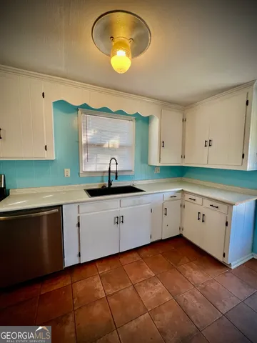 a kitchen with cabinets and window