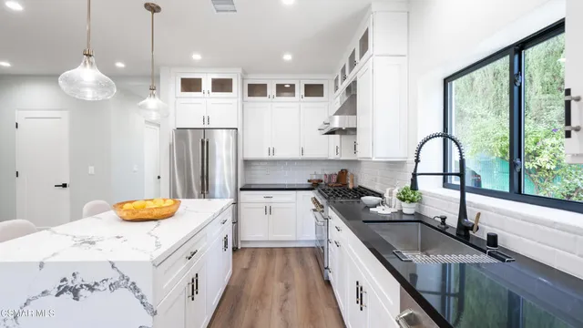 a dining room with furniture a chandelier and wooden floor