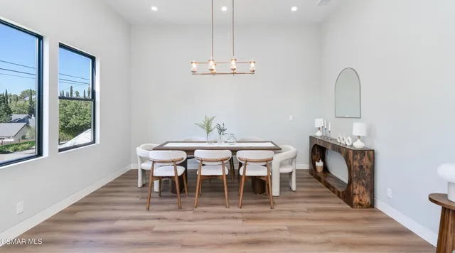 a view of a dining room with furniture and wooden floor