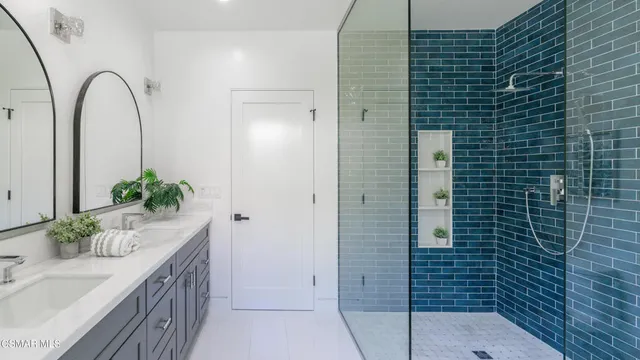 a bathroom with 2 sink and a window