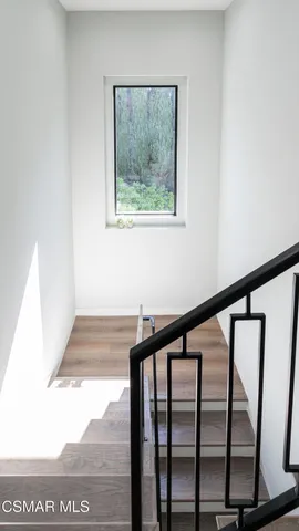 a spacious bedroom with a large bed and a potted plant