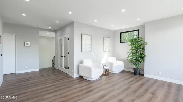 a view of a room with lots of chairs and mirrors