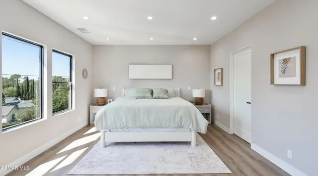 a bedroom with a bed and a painting