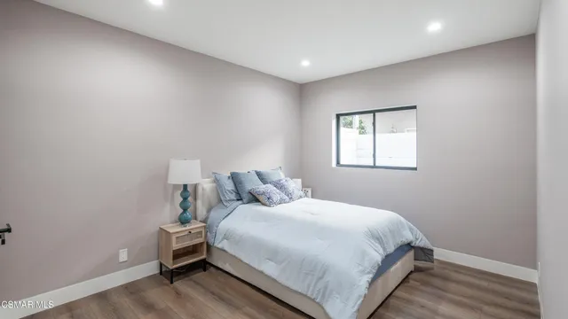 a bedroom with a bed and a large window