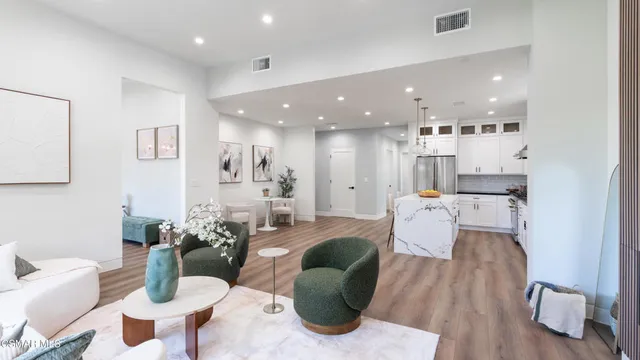 a kitchen with a sink a refrigerator and wooden floor