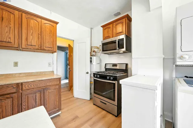 a kitchen with stainless steel appliances granite countertop a stove a sink and a refrigerator
