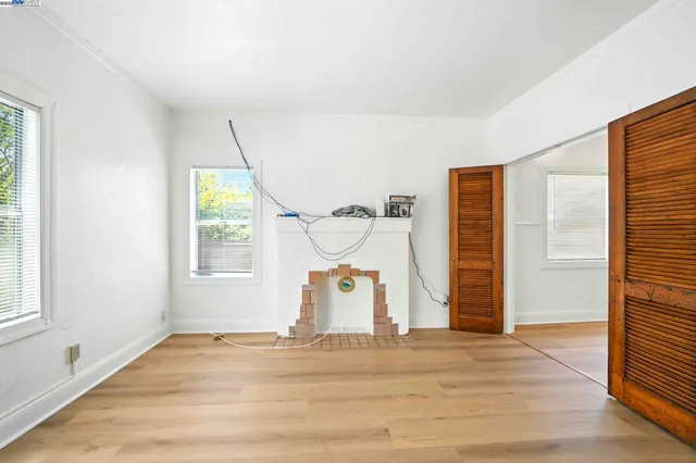 a room with a window and a wooden floor