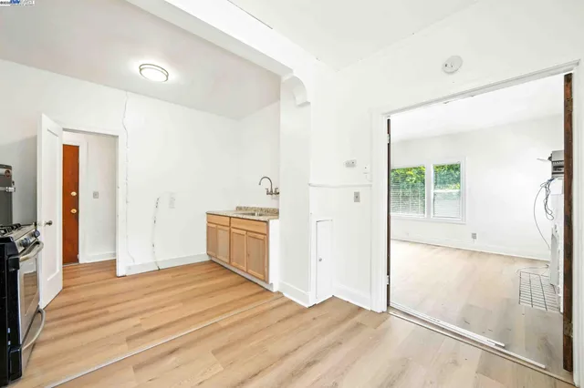a view of a storage & utility room with closet wooden floor