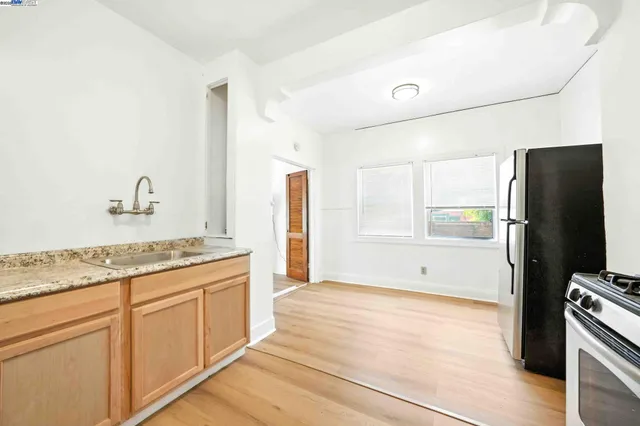 a kitchen with stainless steel appliances granite countertop a refrigerator and a stove